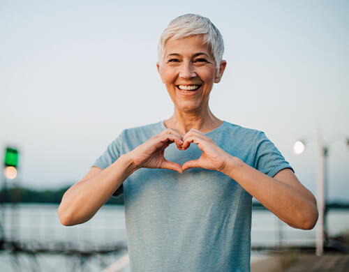 woman making a heart with her hands